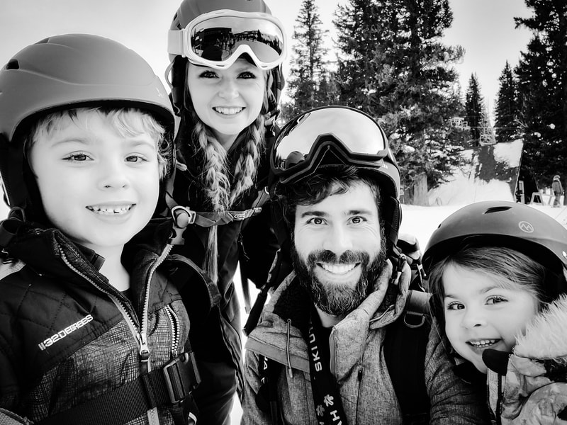 Kyle Evans skiing with his wife, son and daughter